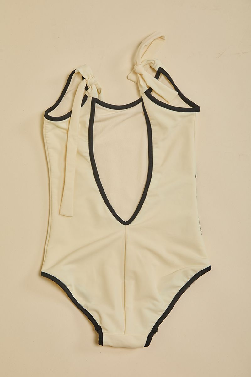 Niña-Entera-Tini-tricot-hueso-con-vivos-negros--1-